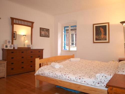 a bedroom with a bed and a dresser and a mirror at Apartment 11 in Rovinj