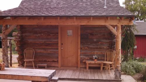 a cabin with two chairs and a table on a deck at Cooper's Cabin at The Osborne in Spring City