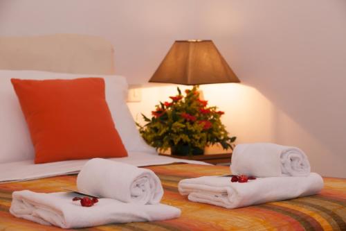 a hotel room with towels on a bed with a christmas tree at Il Convento sul Mare in Santo Stefano al Mare