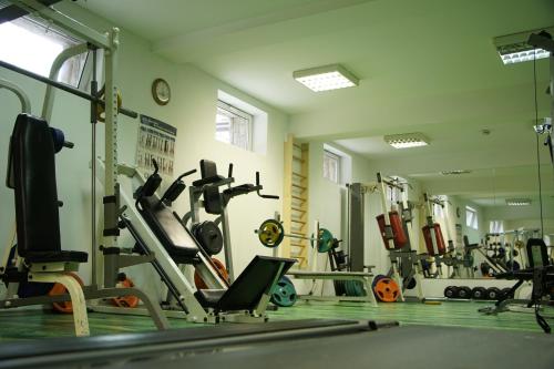 a gym with cardio equipment and a mirror at Spa Hotel Dvoretsa in Velingrad