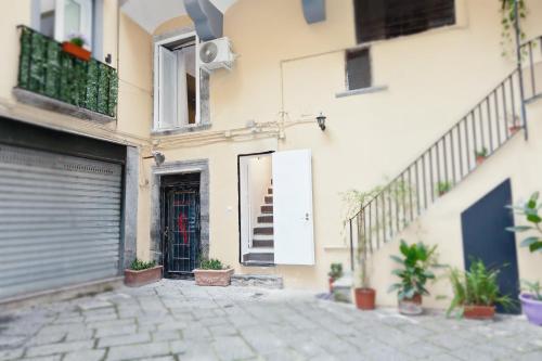 a building with a gate and a door with a staircase at Casa Velata a Spaccanapoli in Naples