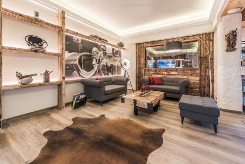 a living room with a couch and a table at VÖTTER'S HOTEL in Kaprun - summer card included in Kaprun