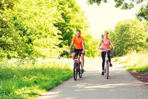 a man and a woman riding bikes down a path at Best Western Hotel Lippstadt in Lippstadt