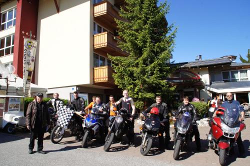 a group of people on motorcycles in front of a building at VÖTTER'S HOTEL in Kaprun - summer card included in Kaprun