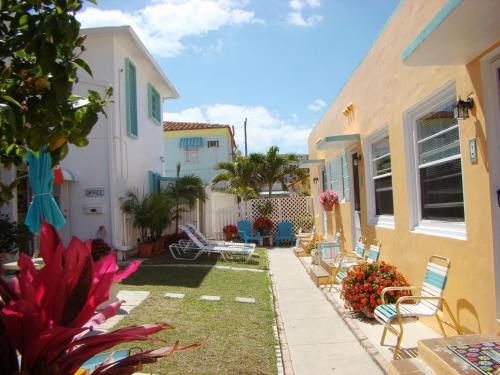 a yard with chairs and a house at Atlantic Sands Beach Suites in Hollywood