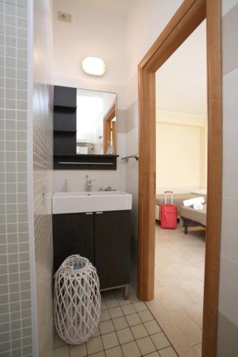 a bathroom with a sink and a mirror at Hotel Tosi in Riccione