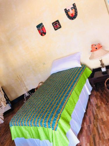a bedroom with a bed with pictures on the wall at Taino Cove in Treasure Beach