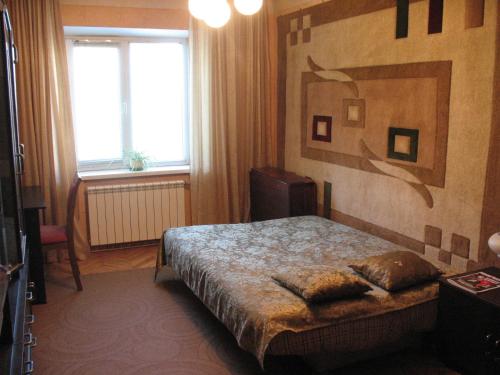 a hotel room with a bed and a window at Apartments near POLITECH in Kyiv