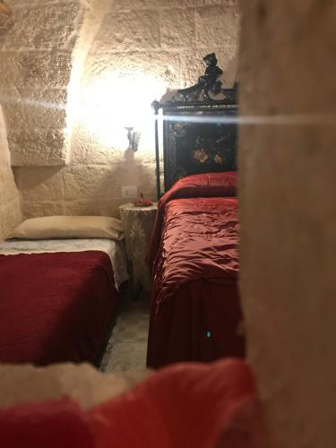 a small room with two beds and a window at Palazzo Savoia 1856 in Fasano
