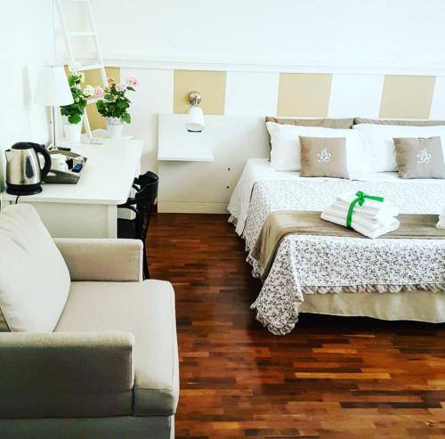 a living room with two beds and a couch at Attico Barocco in Lecce