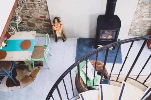 a room with a fireplace and a woman standing in a room at Hillside Lodge in Rostrevor