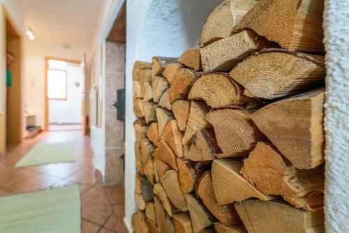 a wall of wood logs in a hallway at Haus Marieus in Umhausen