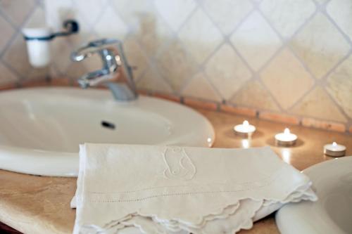 a bathroom with a sink and a towel on a counter at Residenza Storica Casale Pozzuolo in Cinigiano
