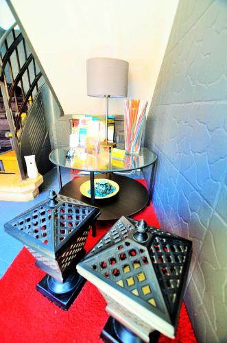 a room with a table and a lamp on a red carpet at Suites & Apartments DP VFXira in Vila Franca de Xira