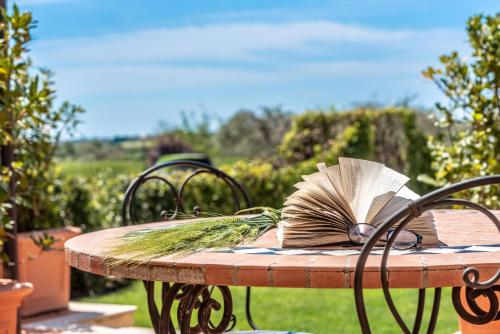 a table with an open book on top of it at Torre Don Virgilio Country Hotel in Cannizzara