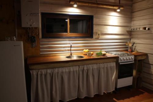 a kitchen with a sink and a stove at Angelo in Punta Del Diablo
