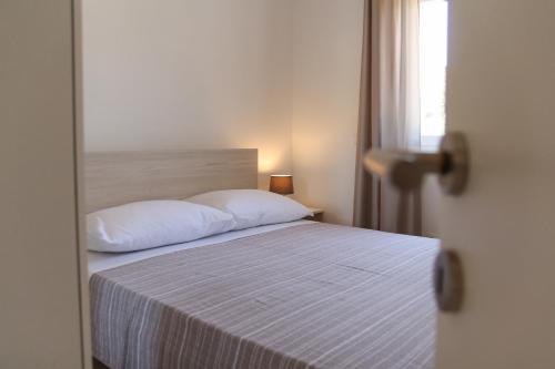Postel nebo postele na pokoji v ubytování Apartments Insula