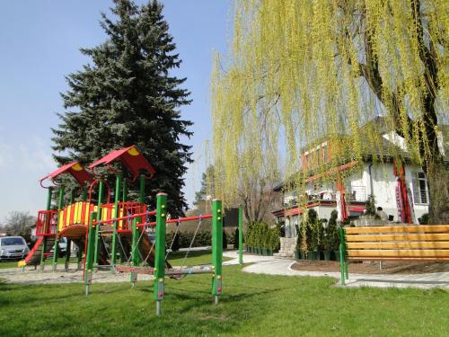 a playground in a park next to a tree at Pokoje gościnne WiP in Cieszyn