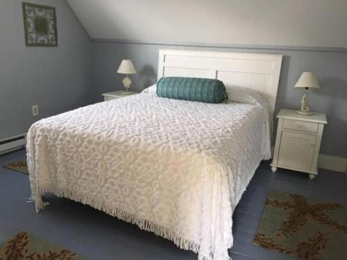 a bedroom with a white bed and two night stands at Newagen Seaside Inn in Southport