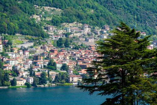 a view of a town on a hill next to a lake at Appartamento Persico - Lake view and private parking in Torno