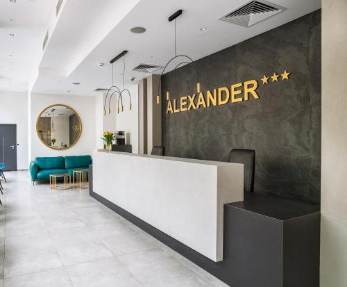 a lobby of alderman with a reception counter and chairs at Hotel Alexander in Kraków