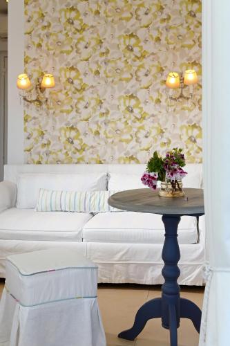 a living room with a table and a couch at Mare Monte Small Boutique Hotel in Chrysi Ammoudia