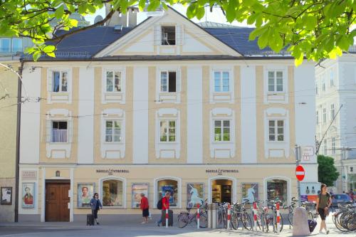a large building with bicycles parked in front of it at Sishaus - View at Mozarts in Salzburg