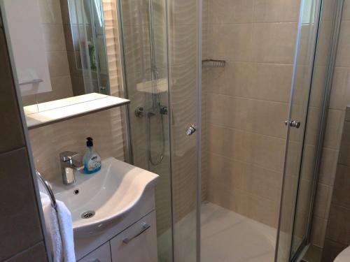 a bathroom with a shower and a sink at Apartments Nevenka i Josko in Tučepi