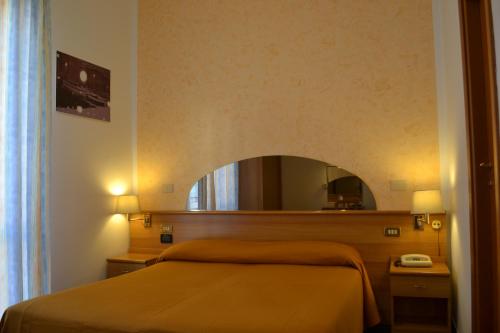 Postel nebo postele na pokoji v ubytování Hotel Villa Camilla
