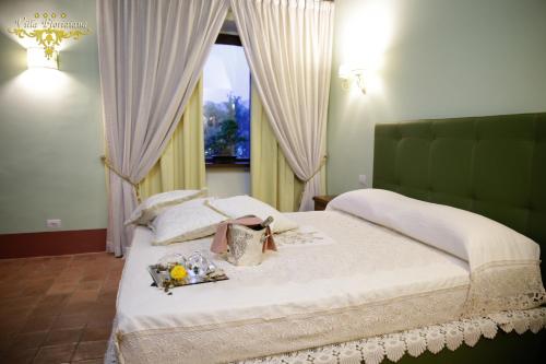 a bedroom with a large bed with a window at Villa Floridiana in Anagni