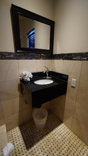 a bathroom with a sink and a mirror at Trylon Hotel - Hollywood in Los Angeles