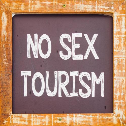 a sign that says no ex tourism on a wooden wall at Economy Apart in Natal