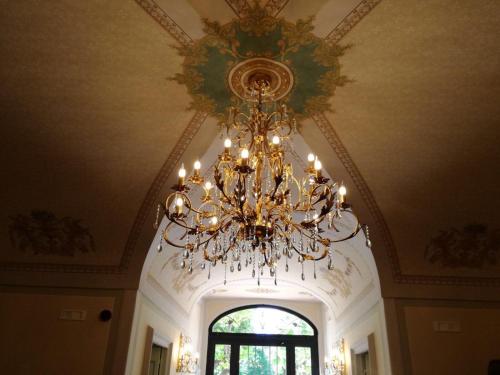 a chandelier hanging from a ceiling with a window at Villa Floridiana in Anagni