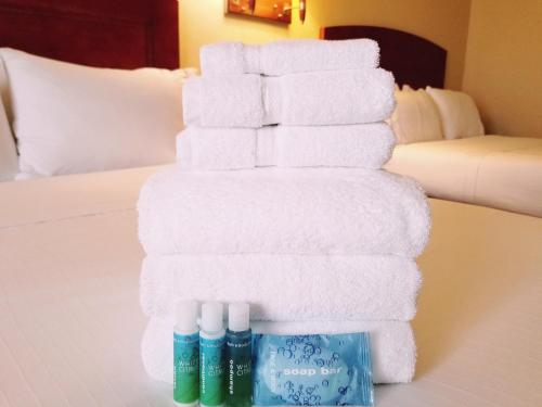 a stack of towels on a bed in a hotel room at Beach Boutique Hotel in Rehoboth Beach