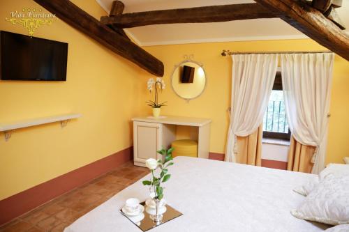 a bedroom with a bed and a tv on the wall at Villa Floridiana in Anagni