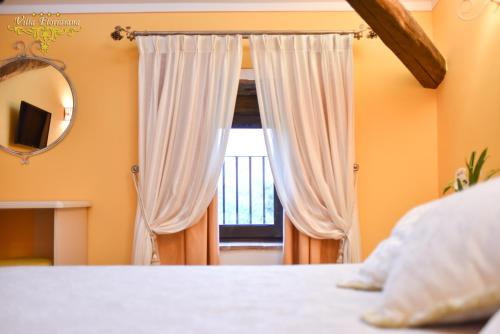 a bedroom with a bed and a window at Villa Floridiana in Anagni
