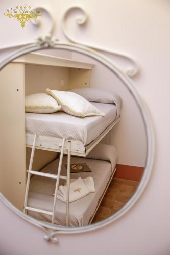 a mirror reflection of a bed in a room at Villa Floridiana in Anagni