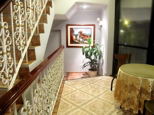 a hallway with a staircase with a table on the floor at Solis Dies Hotel in Lima