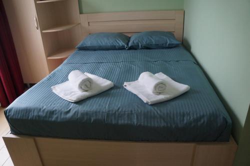 a bed with two white pillows on top of it at Gold Guest House in Gonio
