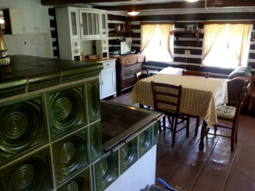 a kitchen with a table and a dining room at Chata Fojtka in Fojtka