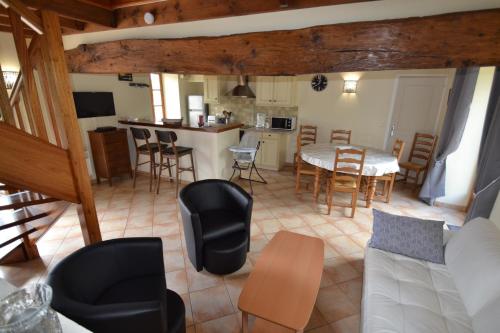 a living room and kitchen with a table and chairs at les gîtes de l'argenterie à 15km du zoo de Beauval classés 4 étoiles in Fontguenand