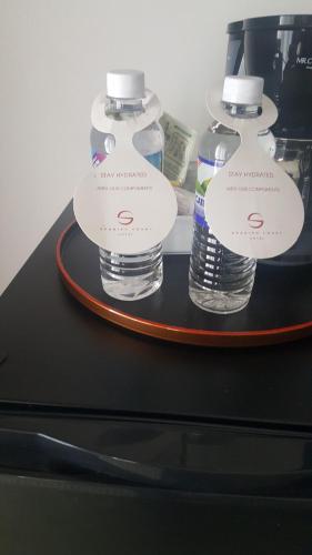 two bottles of water sitting on a black table at S Hotel Kingston in Kingston