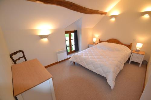 a bedroom with a bed and a table and lights at les gîtes de l'argenterie à 15km du zoo de Beauval classés 4 étoiles in Fontguenand
