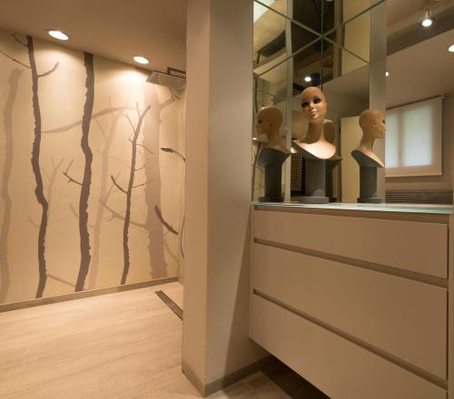 a room with a display case with mannequins in it at B&B Villa dei Calchi - Suite Room di Charme in San Felice sul Panaro