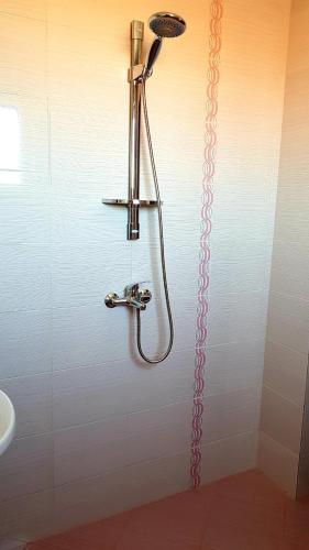 a shower in a bathroom next to a sink at АМИДА in Varvara