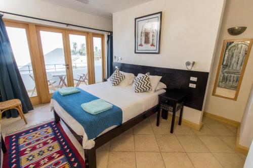 a bedroom with a bed and a balcony at Red C Villas in Dahab