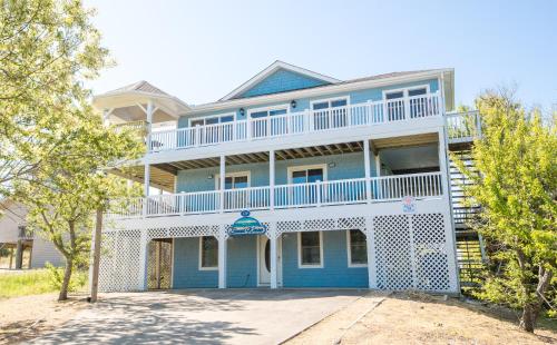 a large blue and white house with a balcony at Sound Waves in Duck