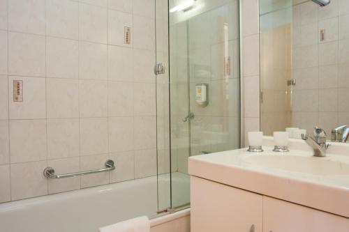 a bathroom with a sink and a shower at Hôtel des Bains d'Ovronnaz in Ovronnaz