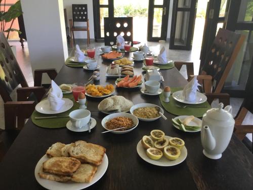 a table full of breakfast food on a table at Sath Villa Naadi Ayurveda Resort in Moragalla