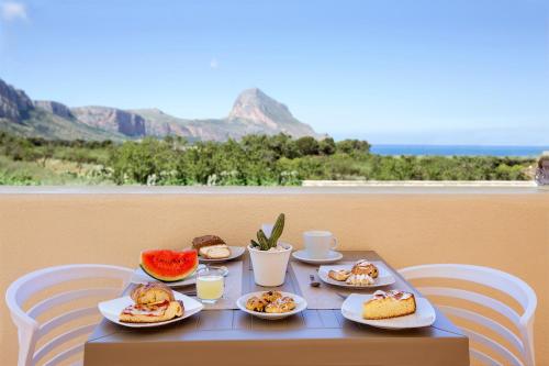 a table with plates of food on top of it at Cala di Ponente in Castelluzzo